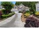 Charming two-story home with a well-maintained lawn, stone steps, and a driveway leading to a two-car garage at 3450 Merganser Ln, Alpharetta, GA 30022