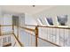 A bright upstairs hallway features a wood and white railing and natural lighting at 3450 Merganser Ln, Alpharetta, GA 30022