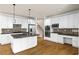 Modern kitchen boasting an island, white cabinetry, and stainless steel appliances at 3450 Merganser Ln, Alpharetta, GA 30022