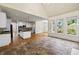 Open concept living room with cathedral ceilings, large windows, and an eat-in kitchen in the background at 3450 Merganser Ln, Alpharetta, GA 30022