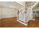 Bright living room featuring hardwood floors, a staircase, and classic trim work at 3450 Merganser Ln, Alpharetta, GA 30022