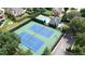 Aerial view of community tennis courts and swimming pool surrounded by lush greenery and mature trees at 3450 Merganser Ln, Alpharetta, GA 30022