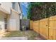 Fenced-in backyard with a small grassy area, a door, and an AC unit at 4217 High Park Ln, Atlanta, GA 30344