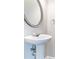 Elegant pedestal sink with oval mirror, adding a touch of modern sophistication to the bathroom at 4217 High Park Ln, Atlanta, GA 30344