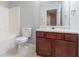 This is a bathroom featuring neutral wall color and tile and a wood vanity cabinet at 4217 High Park Ln, Atlanta, GA 30344