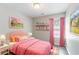 Charming pink bedroom is furnished with bed, bedside tables and decor that create a delightful space at 4217 High Park Ln, Atlanta, GA 30344