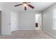 A serene bedroom featuring neutral paint, carpet, ceiling fan and two doors at 4217 High Park Ln, Atlanta, GA 30344