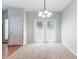 Dining room with carpet, light fixture, and access to back patio at 4217 High Park Ln, Atlanta, GA 30344