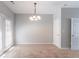 Empty dining room features carpet, neutral paint and french doors at 4217 High Park Ln, Atlanta, GA 30344