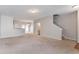 Open-concept living area with neutral carpet, stairs, and access to the dining area at 4217 High Park Ln, Atlanta, GA 30344