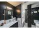 Modern bathroom featuring sleek black walls, marble countertop and shower with glass door at 1026 Saint Charles Ne Ave # 15, Atlanta, GA 30306