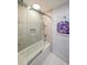 Modern bathroom featuring tiled walls, a bathtub, and a glass shower door at 1026 Saint Charles Ne Ave # 15, Atlanta, GA 30306