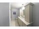 Bathroom featuring light grey vanity with white countertop, a mirror, and tiled shower at 1026 Saint Charles Ne Ave # 15, Atlanta, GA 30306