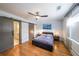 Bedroom with hardwood floors, a ceiling fan, sliding doors, and an ensuite bathroom at 1026 Saint Charles Ne Ave # 15, Atlanta, GA 30306