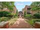Charming brick apartment complex with landscaped walkway, benches, and awning-covered entrances at 1026 Saint Charles Ne Ave # 15, Atlanta, GA 30306