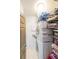 Compact laundry area with stacked washer and dryer, shelving, and storage in a well-lit space at 1026 Saint Charles Ne Ave # 15, Atlanta, GA 30306