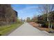 Scenic walking path with trees, landscaping, and modern buildings in the background at 1026 Saint Charles Ne Ave # 15, Atlanta, GA 30306