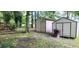 Backyard featuring lush greenery, two storage sheds, and fenced in area, providing ample space for outdoor activities at 200 Fox Hall Court Ct, South Fulton, GA 30349