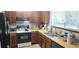 Traditional kitchen with wooden cabinets, tile backsplash, and modern appliances at 200 Fox Hall Court Ct, South Fulton, GA 30349
