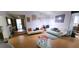 Spacious living room with light wood floors, white sofas and multiple doorways to other rooms at 200 Fox Hall Court Ct, South Fulton, GA 30349
