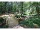A wooden bridge in the backyard leads to a tranquil stream and verdant landscape at 2505 Midway Rd, Decatur, GA 30030