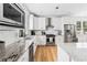 A modern kitchen featuring stainless steel appliances, granite countertops, and white cabinets at 2505 Midway Rd, Decatur, GA 30030