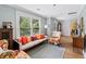 Bright living room featuring hardwood floors, a sofa, and large windows at 2505 Midway Rd, Decatur, GA 30030