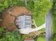 Aerial view of home featuring lush landscaping, driveway, fire pit, and pristine lawn enhancing the property's curb appeal at 4250 Green Ridge Dr, Marietta, GA 30062
