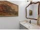 Elegant bathroom features a stone countertop, decorative mirror, and vintage-style artwork at 4250 Green Ridge Dr, Marietta, GA 30062