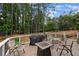Inviting deck with comfortable seating, a grill, and a fire pit, surrounded by lush greenery at 4250 Green Ridge Dr, Marietta, GA 30062