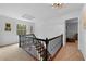 Upstairs hall with hardwood stairs, black metal railing, and natural light, creating an open and inviting atmosphere at 4250 Green Ridge Dr, Marietta, GA 30062