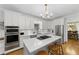 Contemporary kitchen with white cabinets, stainless steel appliances, and a quartz countertop island at 4250 Green Ridge Dr, Marietta, GA 30062