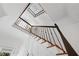 Staircase with wooden steps, white risers, and a decorative black metal railing at 4250 Green Ridge Dr, Marietta, GA 30062