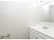 This bathroom features a white sink and cabinets with neutral walls at 6481 Alford Way, Lithonia, GA 30058