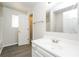 Bathroom features single vanity, ample lighting, and wood-look flooring at 6481 Alford Way, Lithonia, GA 30058