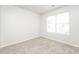 This bedroom features a window with blinds allowing for natural light on top of neutral carpeting at 6481 Alford Way, Lithonia, GA 30058