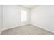 Cozy bedroom with a large window, plush carpet, and neutral walls at 6481 Alford Way, Lithonia, GA 30058