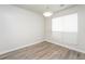 A clean dining room space with modern floors and a window at 6481 Alford Way, Lithonia, GA 30058