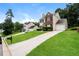 Charming two-story home with a well-manicured lawn and a long driveway leading to a one-car garage at 6481 Alford Way, Lithonia, GA 30058