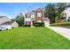 Charming two-story home with brick and siding exterior, manicured lawn and driveway at 6481 Alford Way, Lithonia, GA 30058