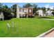 Two-story home with green lawn and trees at 6481 Alford Way, Lithonia, GA 30058