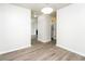 Hallway featuring modern floors with view into the living room and a bathroom at 6481 Alford Way, Lithonia, GA 30058