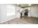 Eat-in kitchen with stainless steel appliances, white cabinetry, and modern floors at 6481 Alford Way, Lithonia, GA 30058