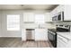 Modern kitchen boasting white cabinets, stainless steel appliances, and a window at 6481 Alford Way, Lithonia, GA 30058