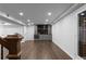 Finished basement features wood floors, wet bar with cabinets and microwave, and adjacent wine cellar at 7110 Northgreen Dr, Atlanta, GA 30328