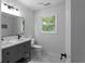 Bathroom featuring double sink vanity, stylish mirror, and modern fixtures at 7110 Northgreen Dr, Atlanta, GA 30328