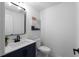 A well-lit bathroom featuring a modern vanity, toilet, and tasteful decor; perfect for guests at 7110 Northgreen Dr, Atlanta, GA 30328