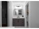 This bathroom features a modern vanity with quartz countertops, sleek lighting, and elegant fixtures at 7110 Northgreen Dr, Atlanta, GA 30328