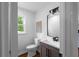 Bathroom featuring modern vanity, mirror, and toilet with a window view at 7110 Northgreen Dr, Atlanta, GA 30328