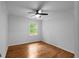 A cozy bedroom featuring hardwood floors, a window, and a ceiling fan at 7110 Northgreen Dr, Atlanta, GA 30328